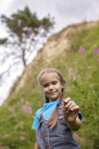 Portrait of girl standing on land