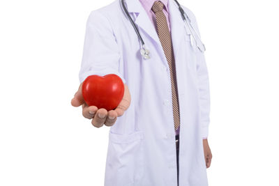 Midsection of person holding red umbrella against white background