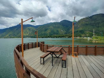 Pier over lake against sky