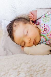 Cute baby sleeping on bed