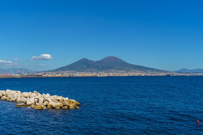 Scenic view of sea against clear blue sky