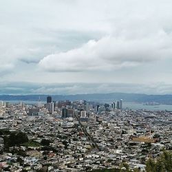 Cityscape against cloudy sky