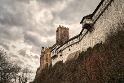 Low angle view of historical building against cloudy sky