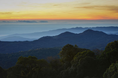 Scenic view of mountains against sky at sunset