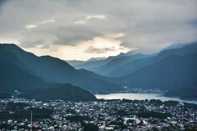 Cityscape against cloudy sky