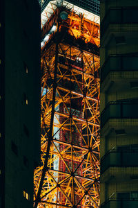 Low angle view of illuminated building against sky at night