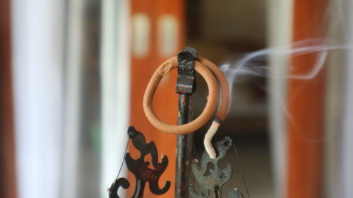Close-up of chain hanging on metal door