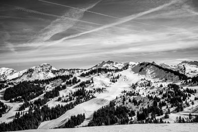 Scenic view of snow covered mountains against sky