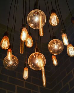 Low angle view of bulbs hanging on ceiling