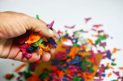 Close-up of hand holding multi colored candies