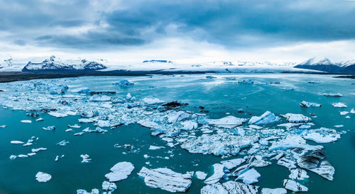 Scenic view of icebergs in jokulsarlon glacier lagoon, iceland, at dusk.