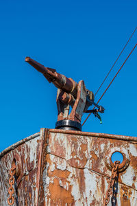 Low angle view of rusty boat against sky