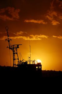 Silhouette of boat against sky during sunset