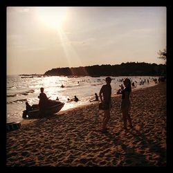 People on beach at sunset