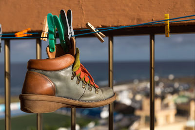 Close-up of shoes hanging on chair