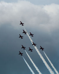 Low angle view of airshow against sky