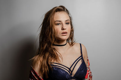 Portrait of a beautiful young woman against white background