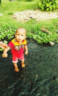 Cute girl standing in water