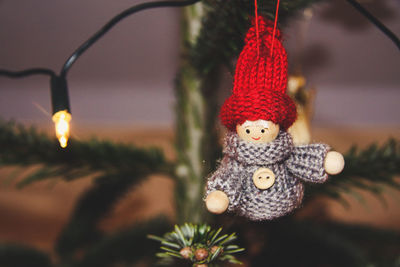 Close-up of doll hanging on christmas tree