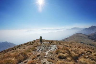 Man standing on mountain against sky