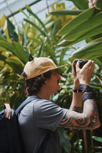 Portrait of woman photographing outdoors