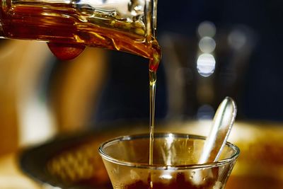 Close-up of coffee pouring in glass