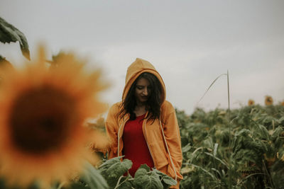 Young woman standing at sunflower farm