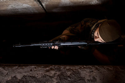 Arab soldier aiming with kalashnikov ak-47 assault rifle.