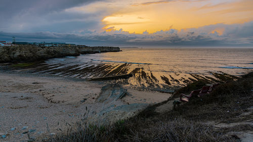 Scenic view of beach against sky during sunset