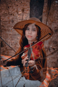 Portrait of young woman wearing hat