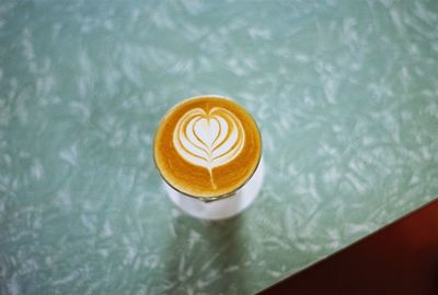 High angle view of cappuccino served on table