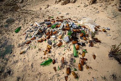 High angle view of garbage on sand