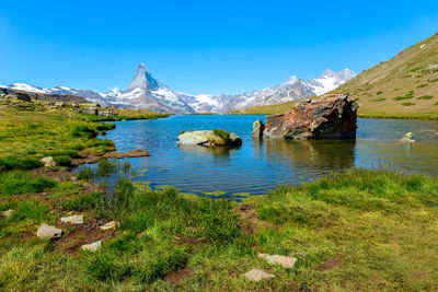 Scenic view of lake and mountains against sky