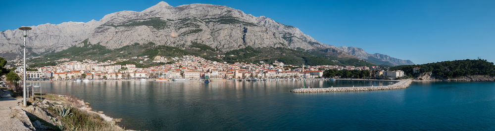 Scenic view of sea by buildings against sky