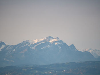 Scenic view of snowcapped mountains against clear sky