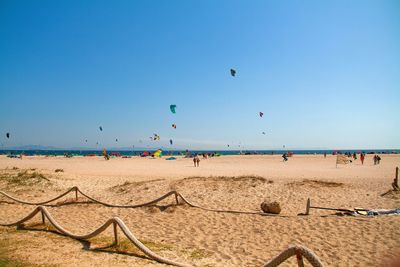 Scenic view of beach against clear blue sky