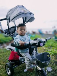 Portrait of boy riding push scooter
