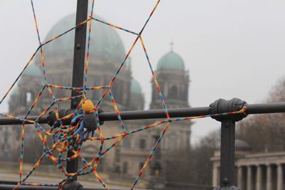 Decoration on railing against berlin cathedral during foggy weather