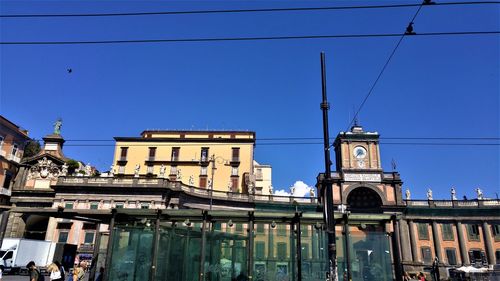 Low angle view of buildings against clear blue sky