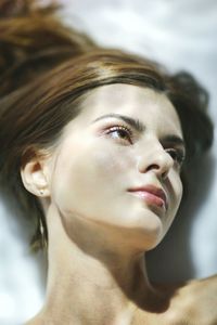 Close-up of thoughtful woman lying in bathtub