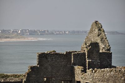 Castle by sea against sky in city