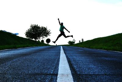 Man skateboarding on road