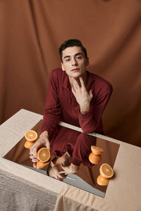 High angle view of man sitting on table