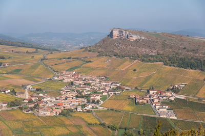 Aerial view of townscape against sky. aerial view of vineyard from mâconnais. solutre
