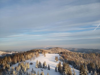 Scenic view of snow covered land against sky