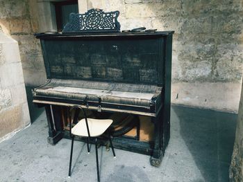 Chair in front of locked piano