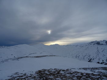 Scenic view of snow covered mountains against sky