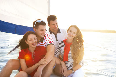 Young couple sitting on boat in water