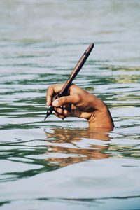 Close-up of hand swimming in water