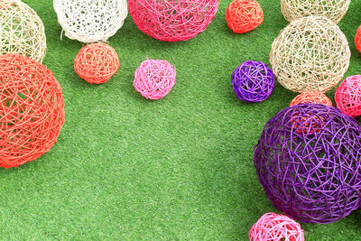 High angle view of colorful straw balls on grass